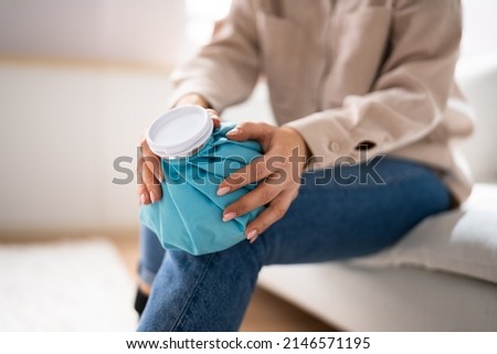 Applying Ice Pack To Knee Joint After Injury Royalty-Free Stock Photo #2146571195