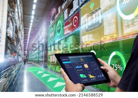 Smart Augmented Reality,AR warehouse management system.Worker hands holding tablet on blurred warehouse as background Royalty-Free Stock Photo #2146588529