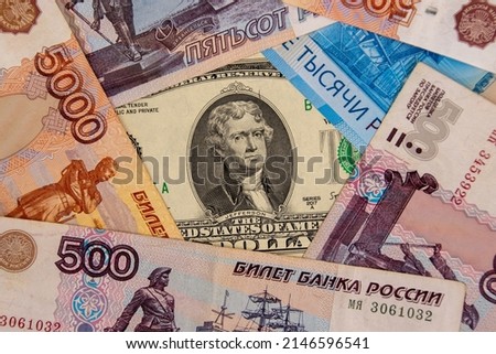 Two dollar banknote surrounded by ruble banknotes