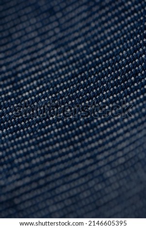 Macro clean bright photo of the blue textured cotton and denim fabric of Jeans and shirt. Pattern and background for fashion and textile production.