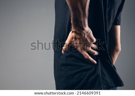 the man's back hurts. kidney pain Royalty-Free Stock Photo #2146609391