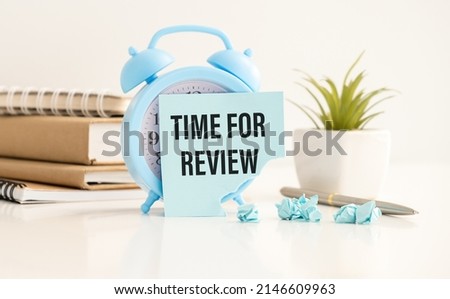 blue alarm clock lies on a blue background next to a card with the text time for feedback. Conceptual business photo on the topic of product evaluation and customer reviews.
