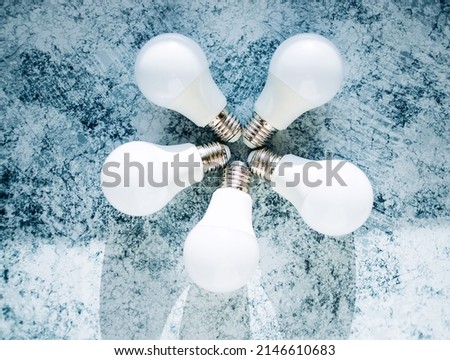 5 white led light bulbs on a blue background