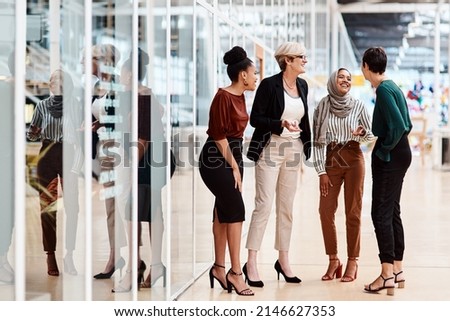 They share a solid friendship as colleagues. Shot of a group of businesswomen chatting to each other in an office. Royalty-Free Stock Photo #2146627353