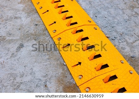 Spike barrier or strip on the road for control the traffic. yellow mechanical spike barrier. Royalty-Free Stock Photo #2146630959