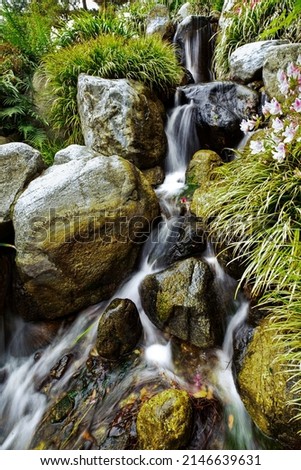 A waterfall splashes over rocks