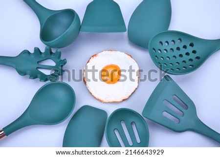 Kitchen utensils for cooking on a gray background.