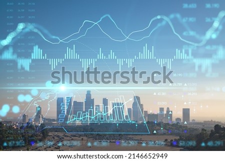 Skyline panorama of Los Angeles downtown at sunset, California, USA. Skyscrapers of LA city. Glowing forex chart hologram. The concept of internet trading, brokerage and fundamental analysis