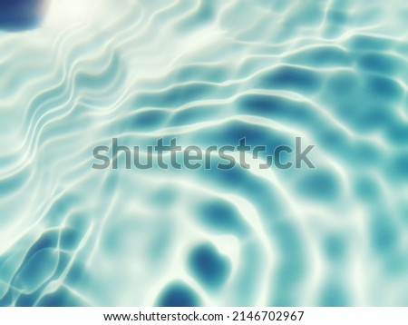 Blur​ abstract​ of​ surface​ blue​ water. Abstract​ of​ surface​ blue​ water​ reflected​ with​ sunlight​ for​ background. Blue​ sea or Blue​ water.​ Water​ splashed​ use​ for​ graphic​ design. Water.