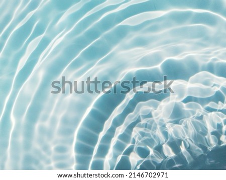 Blur​ abstract​ of​ surface​ blue​ water. Abstract​ of​ surface​ blue​ water​ reflected​ with​ sunlight​ for​ background. Blue​ sea or Blue​ water.​ Water​ splashed​ use​ for​ graphic​ design. Water.