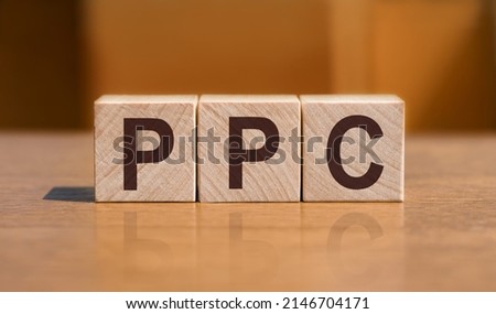 PPC text on wooden cubes on orange background, business concept. PPC short for Pay Per Click Royalty-Free Stock Photo #2146704171