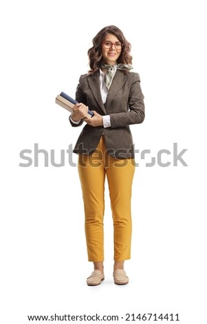Full length portrait of a young female teacher holding books isolated on white background