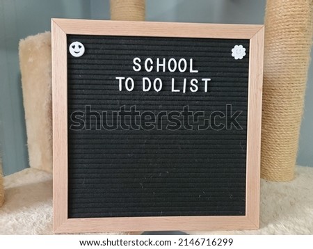 A sign saying school to do list. The felt sign has removable letters than can be moved around to make whatever words or saying one wants. 