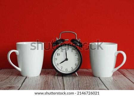 mugs with alarm clock on the table