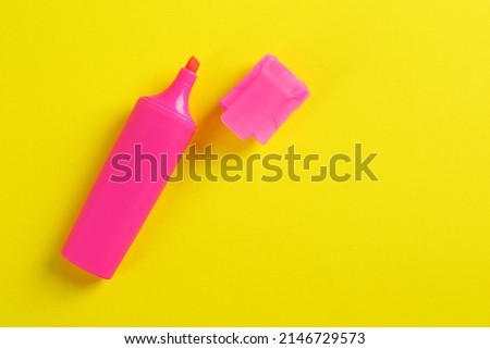 Bright pink marker on yellow background, fat lay. Space for text