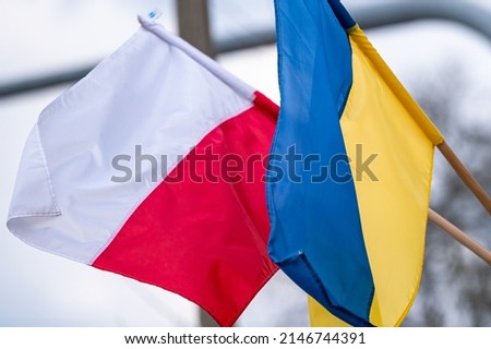 The flag of Poland and Ukraine waving together as a symbol of opposition to Russian aggression. Royalty-Free Stock Photo #2146744391