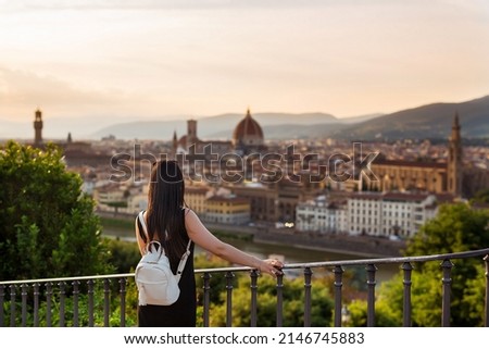 Young woman tourist watching Florence and Cathedral of Santa Maria Del Fiore. Vacation concept with view of Firenze, Italy from Piazzale Michelangelo. Royalty-Free Stock Photo #2146745883