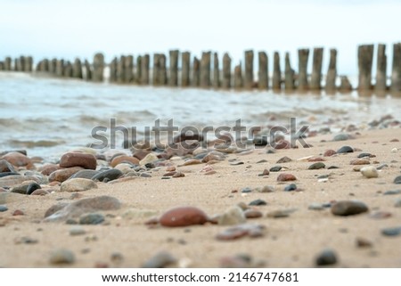 Beautiful mixture of black stones and seashells on sand. View from above . beautiful stones on the seashore. screensaver picture