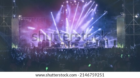 Blurred people watching concert in the park at open air,Summer festival concert.Light from the stage. Royalty-Free Stock Photo #2146759251