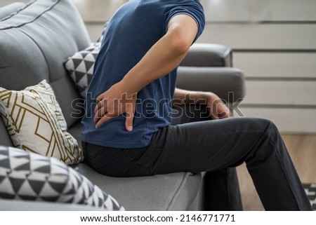 Back pain, kidney inflammation, man suffering from backache at home, health problems concept Royalty-Free Stock Photo #2146771771