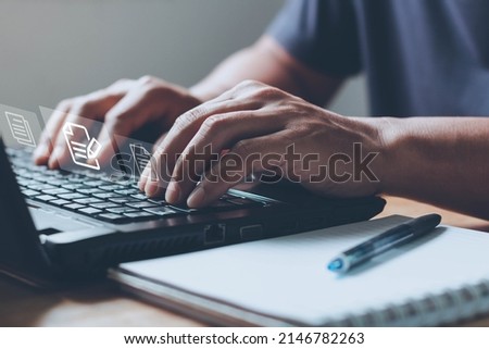 Businessman uses computer laptop for online editing document with the virtual screen. Online documentation database, Document Management System (DMS), Process automation to efficiently manage files.