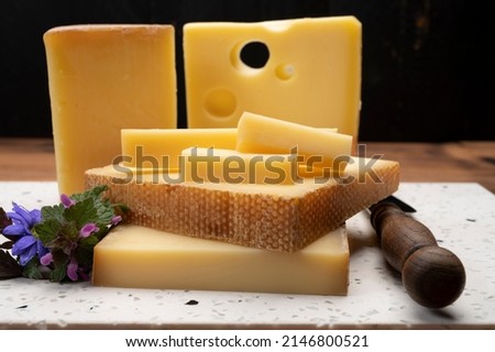 Swiss cheese collection, holes emmentaler and gruyere cheese made from unpasteurized cow's milk close up Royalty-Free Stock Photo #2146800521