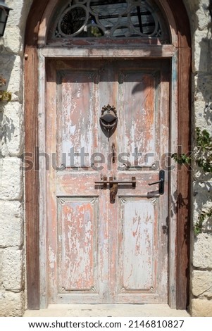 A door is a hinged or otherwise movable barrier that allows ingress (entry) into and egress (exit) from an enclosure.  Royalty-Free Stock Photo #2146810827