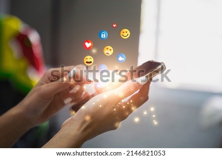 Young woman using smartphone sending emojis. Mobile smartphone sending text messages emoji emoticon. Royalty-Free Stock Photo #2146821053