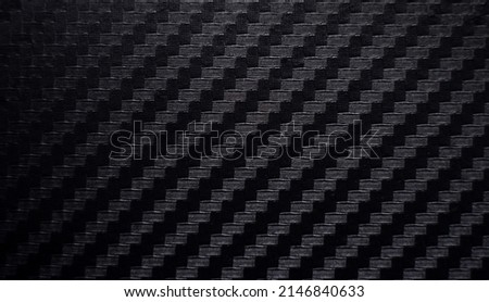 Photo of the texture of black carbon fiber.Sports carbon fiber in dark color. Carbon background.