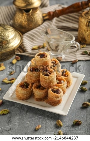 Traditional middle Eastern sweets "bird's nest" with honey and a variety of nut fillings. Delicious honey dessert brown flat plate.