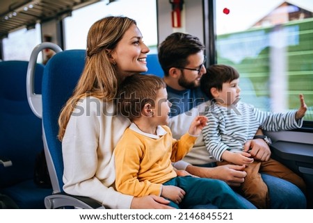 Beautiful happy young family travel together by fast train. Royalty-Free Stock Photo #2146845521