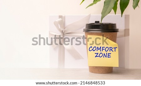A handwritten note on a disposable coffee cup. comfort zone