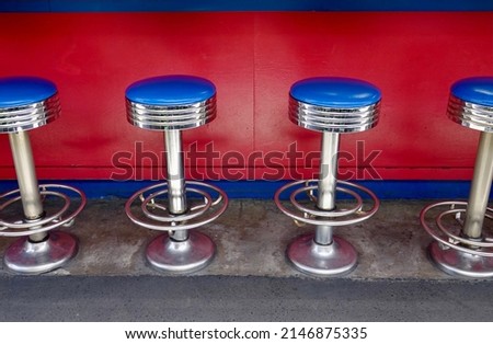 1950's diner with chrome counter stools with blue vinyl seats