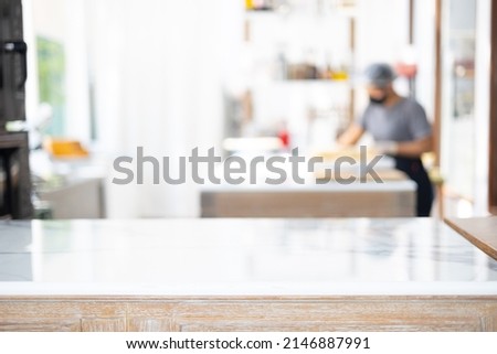 Selective focus and blurred background of beautiful bright and white decorative kitchen with people or chef is working to prepare delicious meal, food and bakery for lunch or dinner. Royalty-Free Stock Photo #2146887991