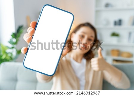 Woman showing smartphone. Blank screen mobile phone for graphic montage. Royalty-Free Stock Photo #2146912967