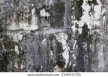 Old black and white distressed concrete wall in Indonesia. Background texture.