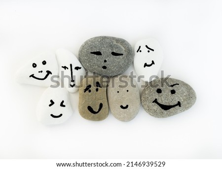 Emotion management concept, stones with painted faces symbolize different emotions. We are all different, but all together. Emotional intelligence, role model. Solidarity, tolerance, teamwork. Royalty-Free Stock Photo #2146939529