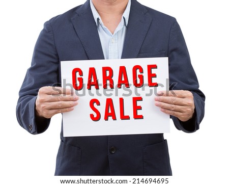 Business man hold garage sale banner isolated on white background