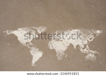 World map dusted on flour craft paper with copy space. World food safety concept. Royalty-Free Stock Photo #2146951851