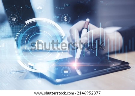 Close up of businessman hand using tablet with digital pen and creative glowing round euro chart hologram on blurry background. Currency, finance and online banking concept. Double exposure