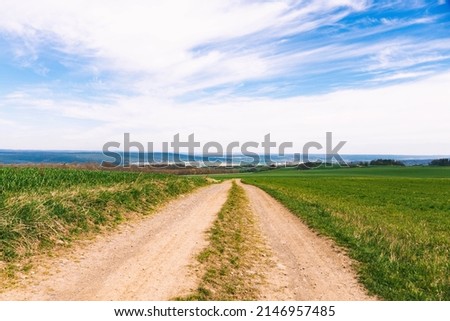 Along a dirt road between fields Royalty-Free Stock Photo #2146957485