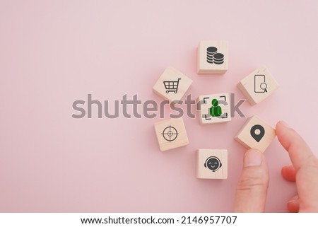 senior businessman's hand hold check in icon on wooden cube block people inside crop in middle for buyer persona and target customer concept, buyer or customer psychology profile or characteristics Royalty-Free Stock Photo #2146957707
