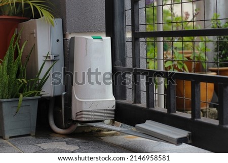 A white automatic gate motor is used to open the gate automatically. Automatic gate is used for security purposes Royalty-Free Stock Photo #2146958581