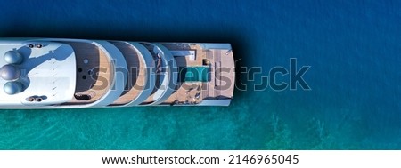 Aerial drone ultra wide photo of latest technology modern silver mega yacht and the only hybrid one called "Savannah" yacht anchored near exotic destination island Royalty-Free Stock Photo #2146965045