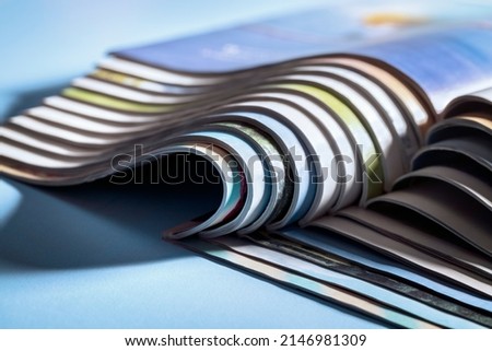 Magazine, brochure or catalogue end on against blue background Royalty-Free Stock Photo #2146981309