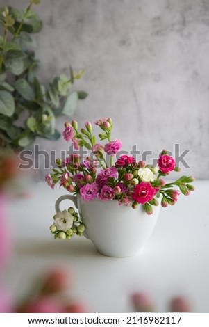 white cup with spring flowers instead of coffee