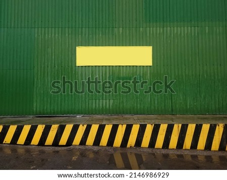 Yellow blank danger warn sign frame copy space for text message or image on the street factory warehouse. Parking place for truck unloading goods