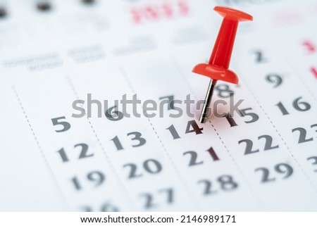 Red push pin on calendar 14th day of the month, mark the Event day with a Pin. Pin on calendar day fourteen, date number 14. Fourteenth day of the month is marked with a red thumbtack Royalty-Free Stock Photo #2146989171