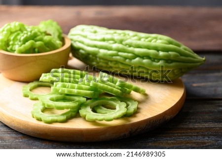 Sliced bitter melon or bitter gourd on wooden board prepare for cooking Royalty-Free Stock Photo #2146989305