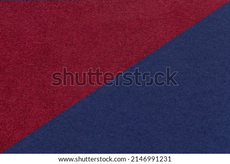 Texture of craft navy blue and dark red paper background, half two colors, macro. Structure of vintage wine craft cardboard. Felt backdrop closeup.